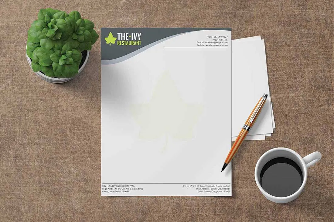 The Ivy Restaurant letterhead photographed with a plant and a cup of coffee