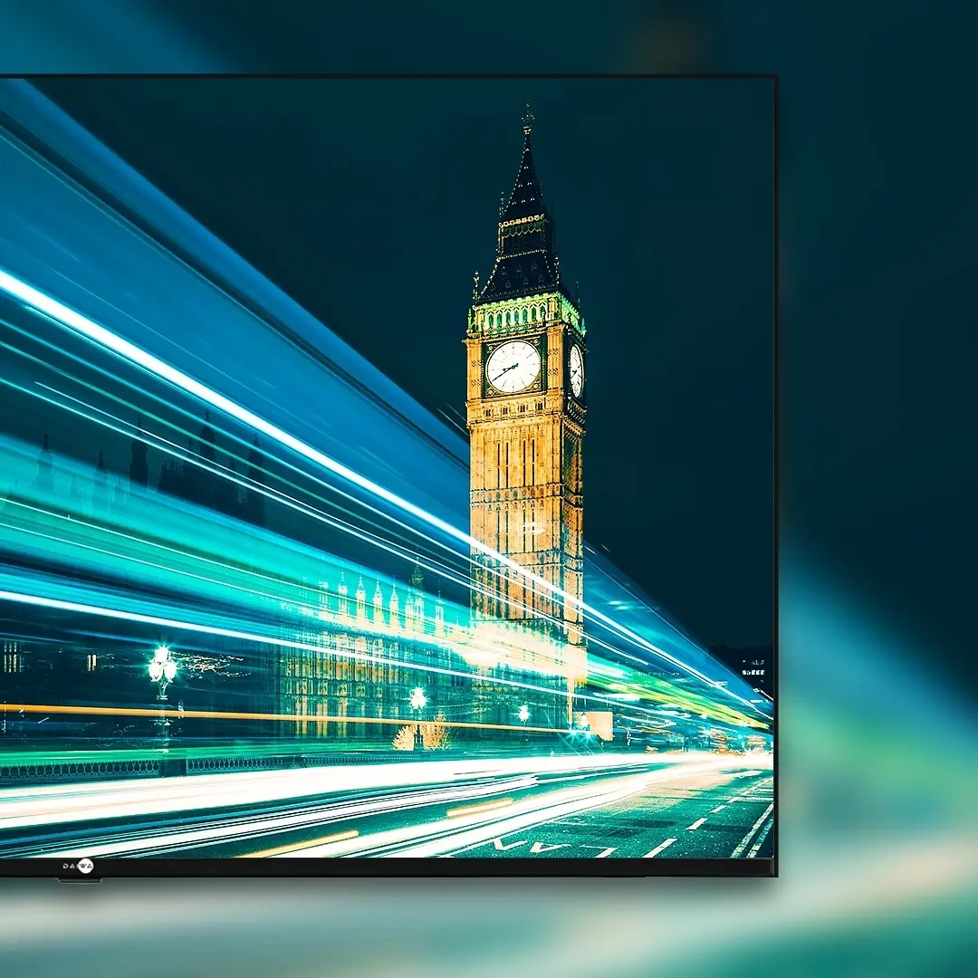TV cropped at the left showing Big Ben at night with light trails streaking along the road