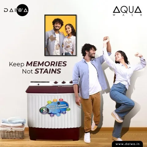 Couple dancing beside a maroon Aqua Wash washing machine, framed photo behind them; headline 'Keep memories not stains'