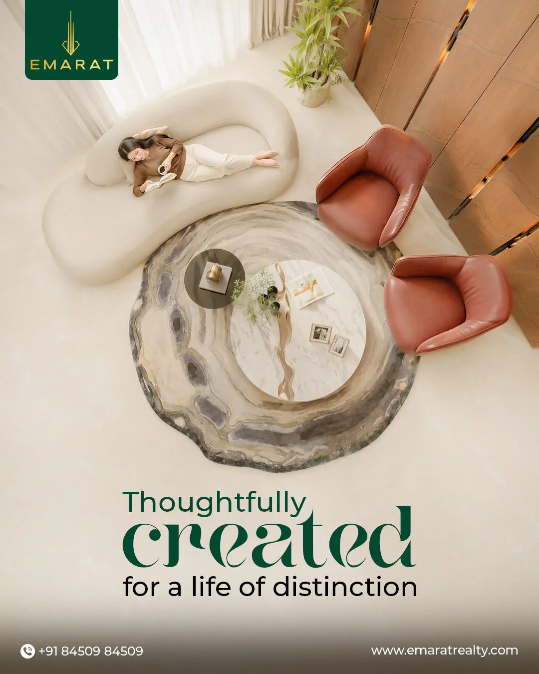 Overhead view of a woman reading on a curved sofa beside a marble table, "Thoughtfully created for a life of distinction"