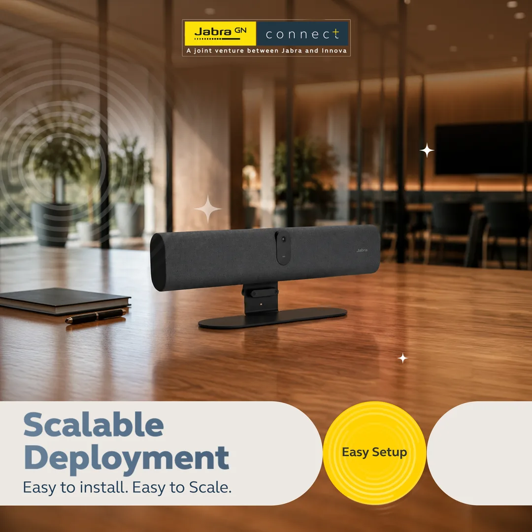 Slide headed Scalable Deployment, with a Jabra video bar on a polished wooden table in a warm-lit glass-walled office