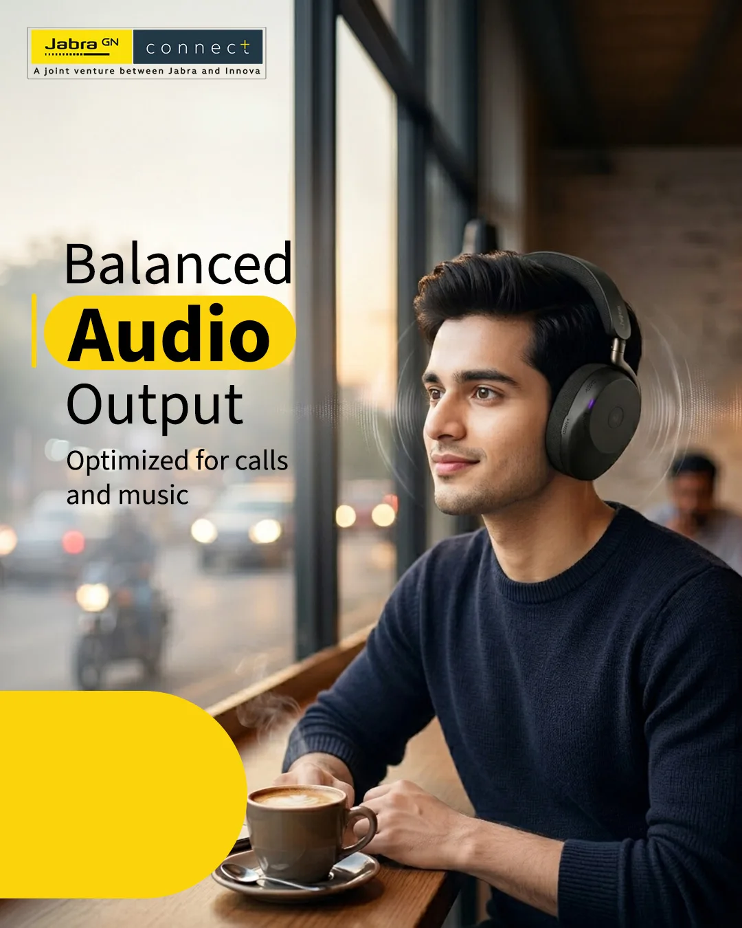 Man in black headphones gazing out a cafe window at a street, coffee in front of him, headline Balanced Audio Output