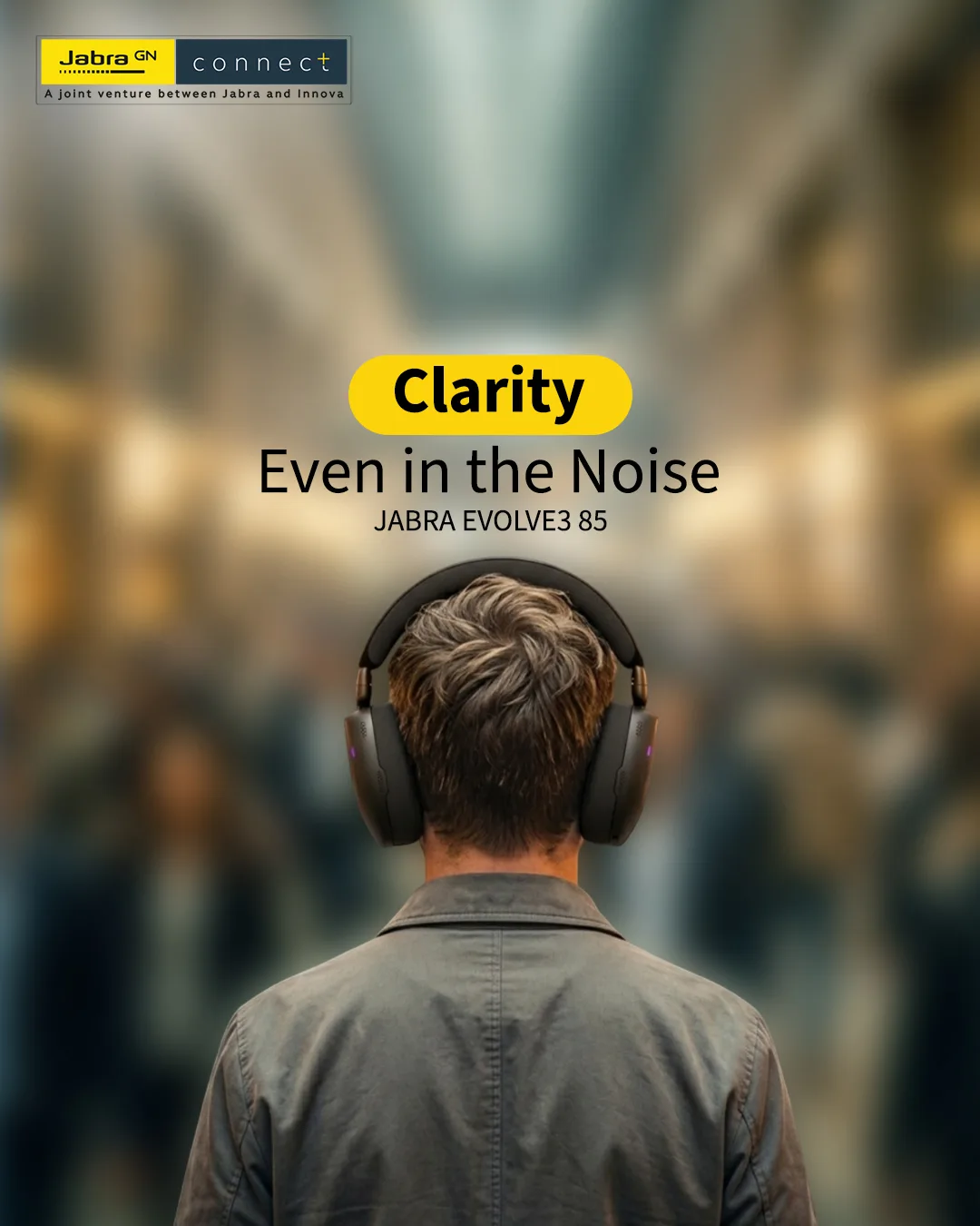 Back view of a man in black headphones facing a blurred crowd, headline Clarity Even in the Noise, Jabra Evolve3 85