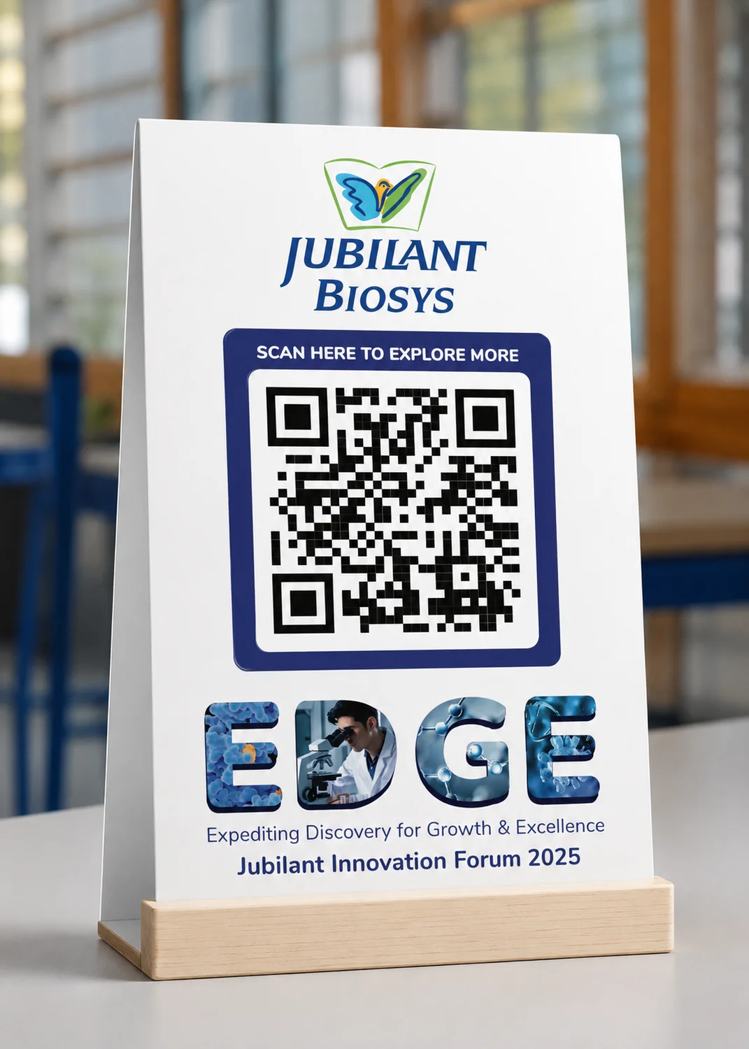 Jubilant Biosys EDGE table standee carrying a QR code, on a wooden base in a laboratory