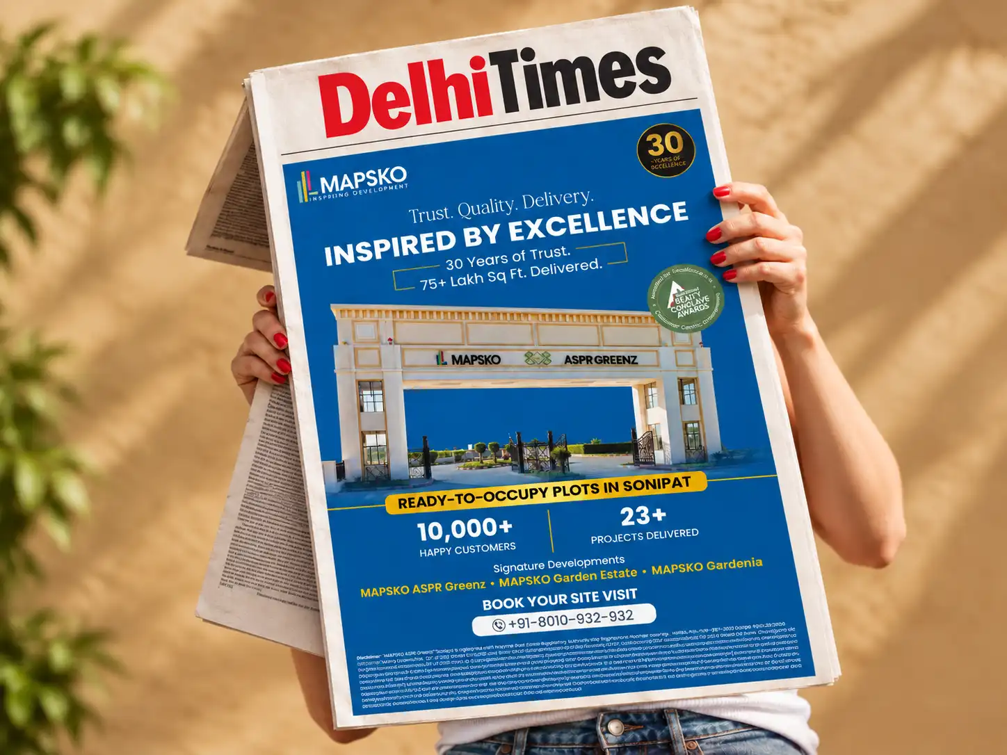 Mapsko Delhi Times newspaper ad reading Inspired by excellence, 30 years of trust, above the ASPR Greenz entrance gate and Sonipat plots