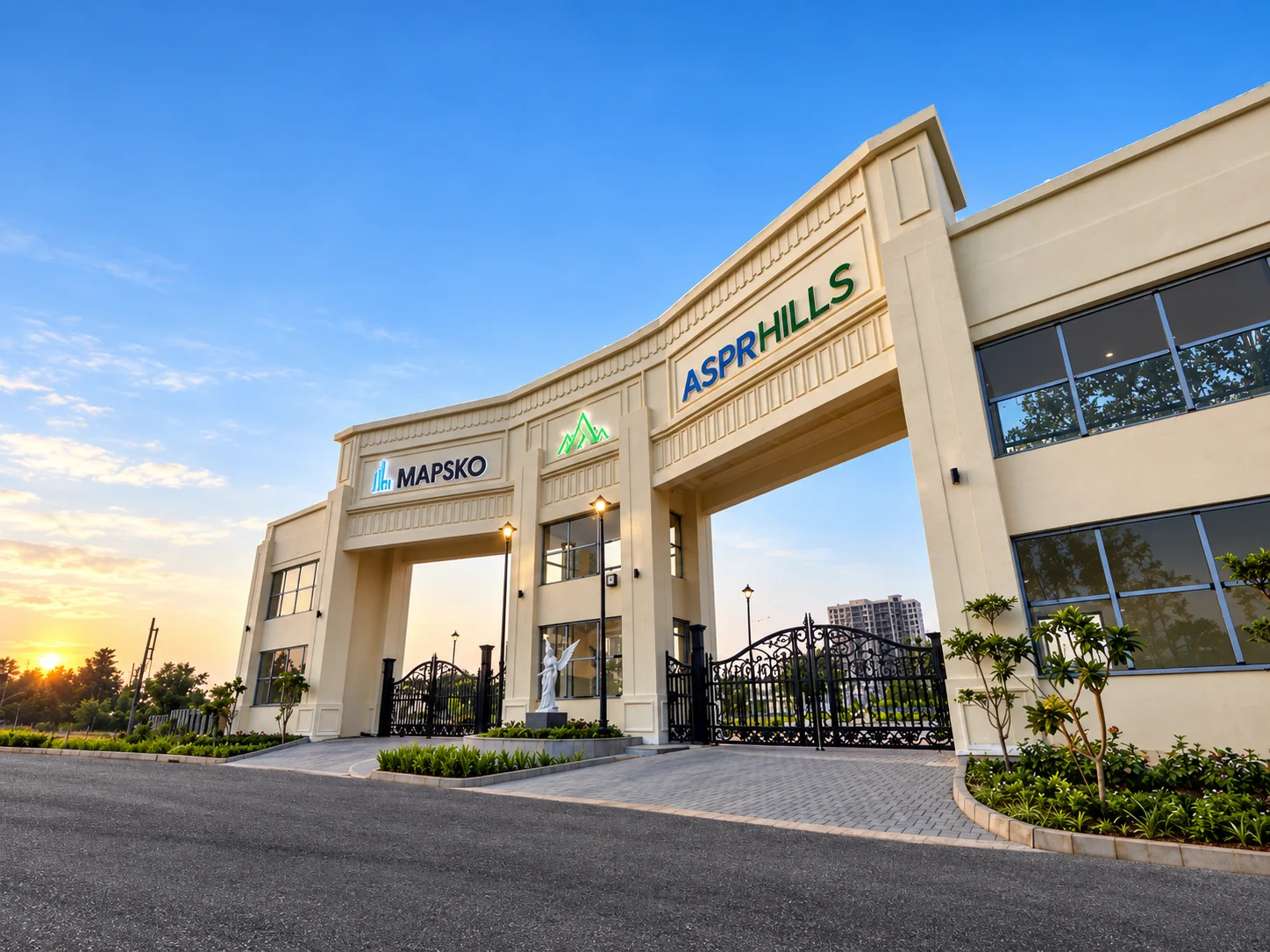 Mapsko ASPR Hills entrance gate at sunset, with the Mapsko and ASPR Hills signs above a wide arch and a black wrought-iron gate