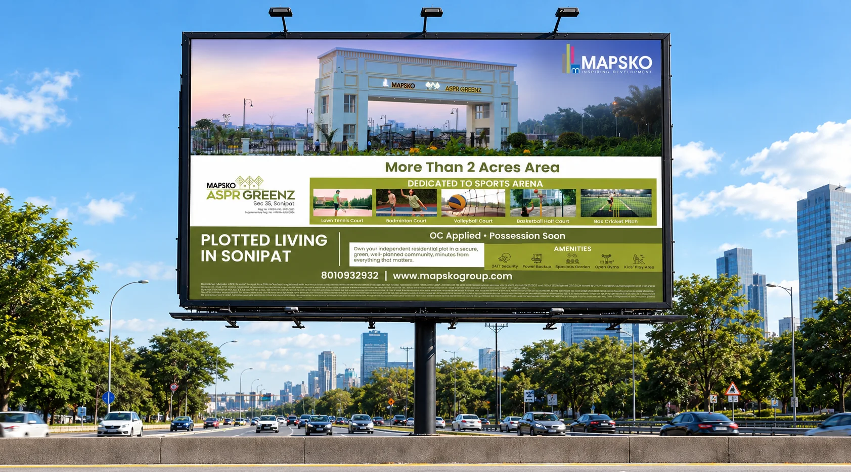 Mapsko ASPR Greenz billboard above a city highway, Sector 35 Sonipat, reading "Plotted Living in Sonipat" over a photo of the entrance gate and a sports-arena strip
